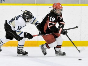 Chatham-Kent Cyclones' Tate Bowden, right, is pulled by Niagara North Stars' Sam Williamson during a round-robin game at the Ontario Hockey Federation atom AAA championship at Thames Campus Arena on Friday. (DIANA MARTIN/The Daily News)