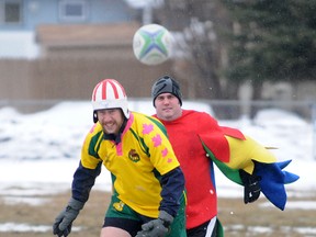 Lloyd Piehl kicks off with Carter Bowles a.k.a. Parrot Man right behind him. Grande Prairie Rugby Club's annual Co-ed Snow Game was held at Macklin Field in Grande Prairie, Alberta on Saturday, April 13, 2013. While not many Albertans were happy with the weekend snow dump, the rugby club was grateful as the conditions for the game were perfect.  TERRY FARRELL/DAILY HERALD-TRIBUNE/QMI AGENCY