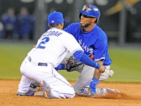 Blue Jays shortstop Jose Reyes hurts his left ankle as he steals second against Kansas City Royals on Friday night. (REUTERS)