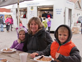 Charlie and Sam Brozina share their pancakes with Aunt Susan Taylor at the second Annual Paris Lions Club Maple Syrup Festival in downtown Paris. (HEATHER CARDLE For QMI Agency)