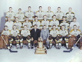 The 1962-63 Kingston Frontenacs pose for a team photo with the Tom Foley Trophy after winning the Eastern Pro Hockey League title. Back, from left: Dick Cherry, Jean Gilbert, Wayne Schultz, Billy Knibbs, Cliff Pennington and Ken Stephanson. Middle: Bun Cook, trainer, Gerry 'Red' Ouellette, Pete Panagabko, Jean-Paul Parise, Ron Willy, Randy Miller, Alf Treen and Tom Dickinson, trainer. Front: Bob Goy, Wayne Connelly, Pat Stapleton, Jim Magee, team president, Wren Blair, GM/coach, Harry Sinden, Don Blackburn and Bruce Gamble.