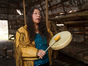 Mary Lou Smoke --2013 Women of Excellence Award for Education, Training and Development -- sings and drums inside a longhouse built at the Museum of Archeology. (MIKE HENSEN, The London Free Press)