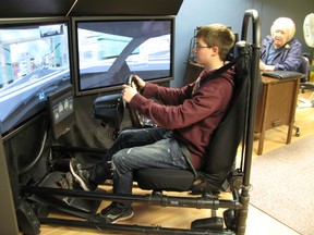 Teenaged driver Alex Corbin of Chatham, Ontario practices his driving skills on a simulator controlled by driving instructor Shirley McLellan of DriveWise Chatham-Kent on Wednesday, April 10, 2013. Insurers are promoting a National Teen Driver Safety Week to be observed in October and making more safety resources available to young drivers. (VICKI GOUGH, Chatham Daily News)