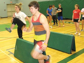 Yanick Rozon and Tyler Boileau lead the way in a simulated hurdles drill at Holy Trinity Catholic Secondary School. Track and field is one of several high school varsity sports coming up over the next two months.