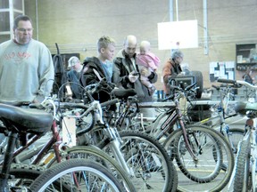 Potential bidders inspect the many bicycles available during the Cornwall police auction held in the Cornwall Armoury, Saturday, April 13, 2013 in Cornwall, Ont.
GREG PEERENBOOM/CORNWALL STANDARD-FREEHOLDER/QMI AGENCY