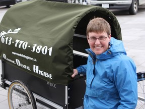 Cindy McQueen, a dental hygienist, has incorporated a bicycle with a trailer in her local practice. McQueen hopes other business owners will adopt a similar business model. (Danielle VandenBrink/The Whig-Standard)