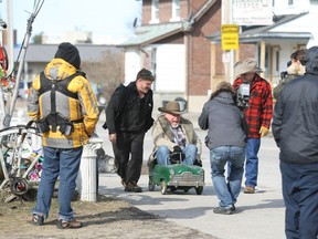 Scott Cozens, one of the Canadian Pickers, rides a pedal car outside Dan Seguin's North Bay home, April 15, 2013. (NUGGET FILE PHOTO)