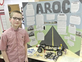 Grade 8 student Declan Mowle stands in front of his project at the Bluewater Regional Science Fair in Owen Sound where he won a gold medal on April 10, 2013. Mowle will be competing at the Canada-Wide Science Fair May 11-18 with his project, the anti roll over car, which helps stabilize vehicles when turning.