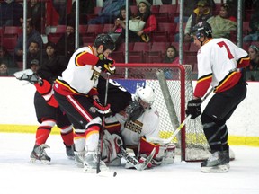 Fisher River’s Scott Cameron makes the save before being bombarded with Cross Lake Islanders rushing the crease. The Fisher River Terriers were defeated 5-3 in the final game of the 2013 North American First Nations Tournament of Champions hockey tournament. The Islanders claimed the championship title and $15,000.
FILE PHOTO/Daily Miner and News