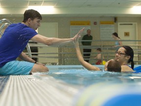 Ben Frid, the Queen’s University student behind the Making Waves program, chats with instructor Jennifer Siu and swim student Nichole McLean. Making Waves caters to special needs children in the area.       Submitted photo - Lars Hagberg