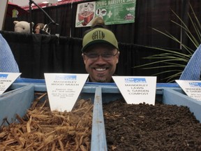 THEODORE STEINER/COLD LAKE SUN
Full-time Manager of the Kinosoo Ridge Ski Hill and part-time distributor for Manderley Turf Grass Jurgen Grau kneels before a selection bin of premium mulches and soil options displayed at the Home and Leisure Trade Show and available through Manderley.  For more pictures see page 30 and for full business descriptions and even more pictures, check out www.coldlakesun.com on Wednesday April 17.