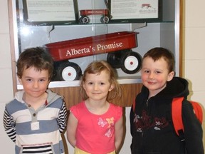 Landon Byers, Jenaya Leipert, and Derek Chretien-Cote stand just outside of the Child Development Centre on the Vemilion campus where they will attend daycare until the centre’s closure June 28. They are standing in front of the red wagon, a symbol of the Government of Alberta’s dedication to ‘improve the lives of Alberta’s children and youth’.