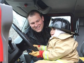 Photo by Jeannette Benoit 
Kalen Garnett takes the opportunity to sit in the driver’s seat of a fire truck at the first Get Outdoors Weekend, put on by the Vermilion chapter of Be Fit For Life. Although the weather was a bit chilly, many people joined to take part in an array of outdoor activities at the event Saturday afternoon.