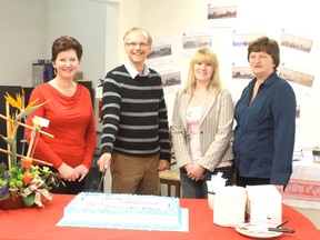 Ad Sales Rep Charlotte Smith, Town Councilor Rob Pulyk, Editor Jeannette Benoit, and Customer Service Rep. Dixie Zizek cut the cake.