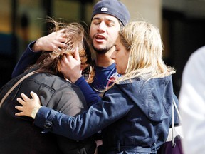 People comfort each other after explosions went off at the 117th Boston Marathon in Boston, Massachusetts Monday. 
REUTERS/Jessica Rinaldi