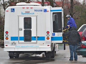 BRIAN THOMPSON, The Expositor

An Operation Lift bus driver uses the vehicle's lift to help a client at a medical centre on West Street.