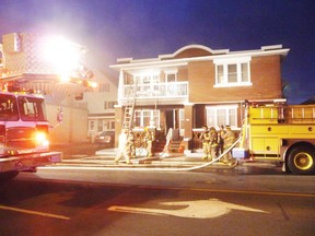 Paramedics took three people to hospital with reportedly minor injuries after a fire engulfed a home on Montreal Road Monday evening. Firefighters got the call to the scene shortly before 7:30 p.m. They were seen on both floors of the four-unit building, and using chainsaws to break in.
Staff photo/KATHRYN BURNHAM