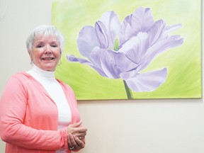 Cathy Rozon stands beside a painting she created that was showcased at the Ingleside Library recently. 
Staff photo/ERIKA GLASBERG