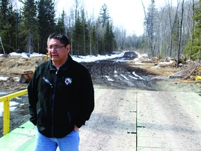 Shoal Lake 40’s Chief Erwin Redsky stands on the temporary metal bridge that first provided a link in February 2013 to Freedom Road, cut 27 kilometres through the forest to the Highway 17.
ALAN S. HALE/Daily Miner and News
