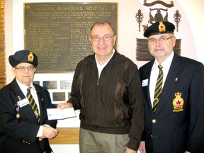 Royal Canadian Legion, Branch 155 Southampton president, Marilyn Noble, left, and executive member Ralph Lynch, right, present $5,000 to Southampton Marine Heritage Society treasurer Tom Mather to help with the purchase of the Peerless II.