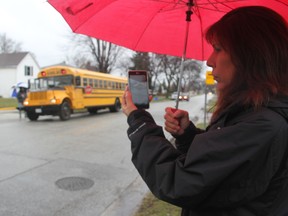 Deb Wyrzykowski films her six-year-old son Brett getting off the school bus at the corner of Devine Street and Westbury Court Thursday. The Sarnia mother says she's taken to videotaping drivers who refuse to stop for the bus when its lights and stop sign arm have been activated. (BARBARA SIMPSON / THE OBSERVER / QMI AGENCY)