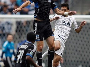 San Jose Earthquakes' Alan Gordon heads the ball against Jun Marques Davidson of the Vancouver Whitecaps during the first half of their MLS soccer match in Vancouver, British Columbia July 22, 2012. (REUTERS/Ben Nelms)