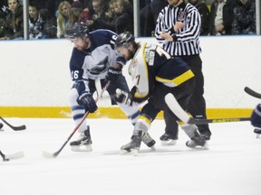 ‘Hawks forward Andy Mitchell right after taking a faceoff vs Tavistock’s Jeff Roes. Both players keep their eye on the puck, ready for anything