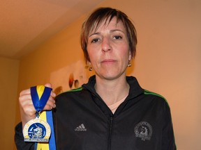 Tillsonburg runner Tammy Kyle, participated in the 115th Boston Marathon in 2011. Kyle shared her experience of the Boston Marathon and thoughts on the tragic events Monday with the Tillsonburg News. She is seen here wearing her Boston Marathon jacket and holding her Boston Marathon medal. 

KRISTINE JEAN/TILLSONBURG NEWS/QMI AGENCY