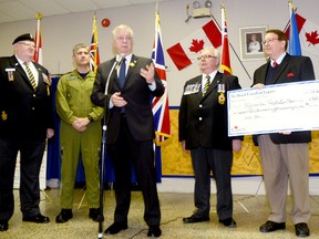 Quinte West Mayor John Williams speaks to members of the Royal Canadian Legion Branch 110 and representatives from the Royal Canadian Legion Dominion Command, as Hugh O'Neil holds a cheque for $160,000 for the Afghanistan Repatriation Memorial. The cheque was presented by Gordon Moore, Dominion president of the Royal Canadian Legion (second from right). Also shown are Branch 110 president Everett MacLean and CFB Trenton base commander Col. Sean Friday. 
Emily Mountney Trentonian