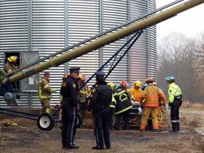 Fire fighters and EMS workers attend to the scene of an industrial accident Tuesday morning. A 60 year-old Bayham Township man was transported to the Tillsonburg District Memorial Hospital and then later transferred to the London Health Sciences Centre after being seriously injured in an industrial accident late Tuesday morning.    

KRISTINE JEAN/TILLSONBURG NEWS/QMI AGENCY