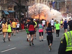 Runners make their way toward the finish line of the Boston Marathon on Monday as an explosive device is set off. Kingston Barb Parker was about a kilometre from the finish line when the two bombs detonated.
Reuters/QMI Agency