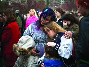 People embrace during a vigil honoring the victims of the Boston Marathon bombings at the Boston Common in Boston on Tuesday. (REUTERS/Shannon Stapleton)