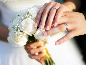 A couple exchanging vows. (Fotolia.com)