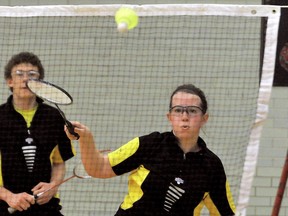 Tilbury Titans' Kate McGregor, right, hits a return as partner Austin Marontate watches during a mixed doubles match Tuesday at the Kent senior badminton championships at Lambton-Kent Composite School. (DIANA MARTIN/The Daily News)