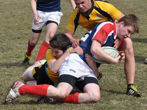 Centre Hastings Centurions' Mitch Thompson and Josh Nicholson haul down St. Paul Falcons' Jaden Rood Monday afternoon in Madoc as the 2013 Bay of Quinte high school boys rugby season got underway with the Centurions and Falcons splitting their junior-senior doubleheader.