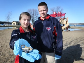 Jessica Brookshaw, left, holds up some cigarette butts at Bluewater Park in Wiarton on Tuesday along with fellow Peninsula Shores District School student William Boulter (JAMES MASTERS The Sun Times)