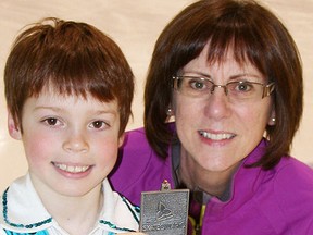 Alec Guinzbourg and his coach, Kim Crothers, with his silver medal from Provincials.