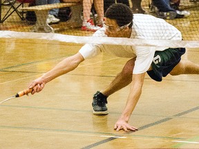 Trenton High Tigers' Leaugen Fray reaches to make a return during the Bay of Quinte high school badminton championships last week at Bayside Secondary School.