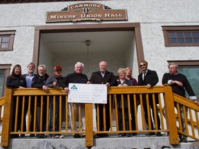 Members of local government and Pine Tree Players board members received a cheque to the tune of $125,000 on Friday, April 12, 2013 to be put towards external restoration of the Miner's Union Hall. Justin Parsons/ Canmore Leader/ QMI Agency