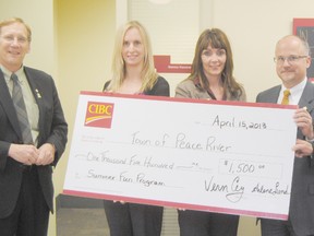 The CIBC Peace River Branch celebrated their 100 years on Monday April 15, 2013. Pictured (l-r): Town of Peace River Mayor Lorne Mann and Town of Peace River Community Programs Coordinator  Laurie Stavne receive a $1,500 cheque for the Summer Fun Program from Branch Manager Arlene Lund, Region Head Mark Galbraith and District Vice-President Vern Cey.