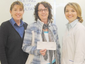 Eleanor Smith (middle), a Fetal Alcohol Spectrum Disorder Mentor/Support Worker accepts a cheque on behalf of Accredited Supportive Living Services (ASLS) from Serena Stojan (left, Shopper’s Drug Mart Front Store Manager) and Monique Lavoie (right, Pharmacist Owner) on Wednesday April 10, 2013 at Shopper’s Drug Mart in Peace River. The $1,600 cheque is from the store’s Tree of Life campaign and monies are generated through donations from store staff and residents.
