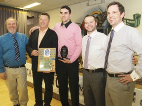 Icemen captain Dylan McKay, centre, receives the Jerry Greene Memorial Award during the Icemen Awards Banquet at Moose Lodge April 12.