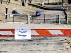 A barricade and sign informs dog owners the John Waddell off-leash park is closed to give the saturated ground an opportunity to dry out and allow crews in to reinstall the garbage pod upended by floods earlier this week. (DIANA MARTIN, Chatham Daily News)