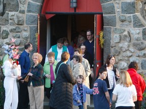 Attendees leave an emotional memorial service held Wednesday, April 17, 2013, at a church in Medford, Mass., for Krystle Campbell, 29, a resident of the small town north of Boston who was killed in the marathon bombings. (CHRIS DOUCETTE/TORONTO SUN)