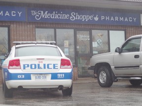 A police cruiser sits outside the Medicine Shoppe on Great Northern Road.