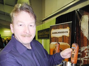 John Picard, owner of Ramblin' Road Brewery Farm, pours a sample of the LaSalette beer at Eat & Drink Norfolk at the Aud on Apr. 13. (SARAH DOKTOR Delhi News-Record)