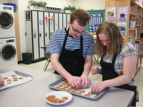 Ecole Secondaire Beaumont Composite High School (ESBCHS) Skills Class students Cory Albert and Alliyah Arnold cook up a tasty pretzel treat in their brand new kitchen inside their classroom at the school on Apr. 17. Their teacher Cassie Gallant first thought of the idea for the kitchen and the community responded generously and quickly with plenty of donations. BOBBY ROY/QMI AGENCY