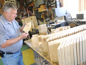 John Remple builds one of 80 birdhouses in his home. Remple donates the houses to schools in the area for student art projects. He estimates that he will build about 500 birdhouses this year. (Aaron Hinks/Daily Herald-Tribune)