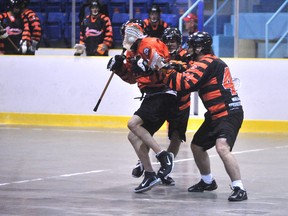 Members of the Sarnia Beavers lacrosse team, in black, give a Sarnia Pacer counterpart a rough time in exhibition action last season. The Beavers open their 2013 schedule Friday night in Oakville. THE OBSERVER/ QMI AGENCY