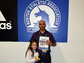 Sherwood Park’s Ravi Devavarapu and his seven-year-old daughter, Nisha, at the sign-in for the Boston Marathon. Devavarapu and his family were a block away from the deadly blasts that killed three. Photo supplied